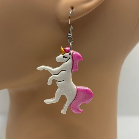 Unicorn-shaped earring on a mannequin ear with a white background