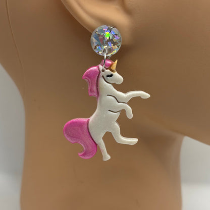 Earring on a mannequin ear with a white background