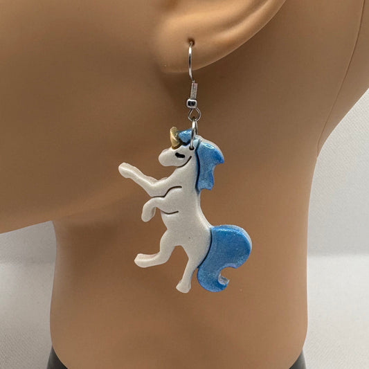 Unicorn-shaped earring on a mannequin ear with a white background