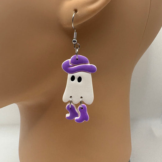 Earring on a mannequin ear with a white ghost design and purple accents.